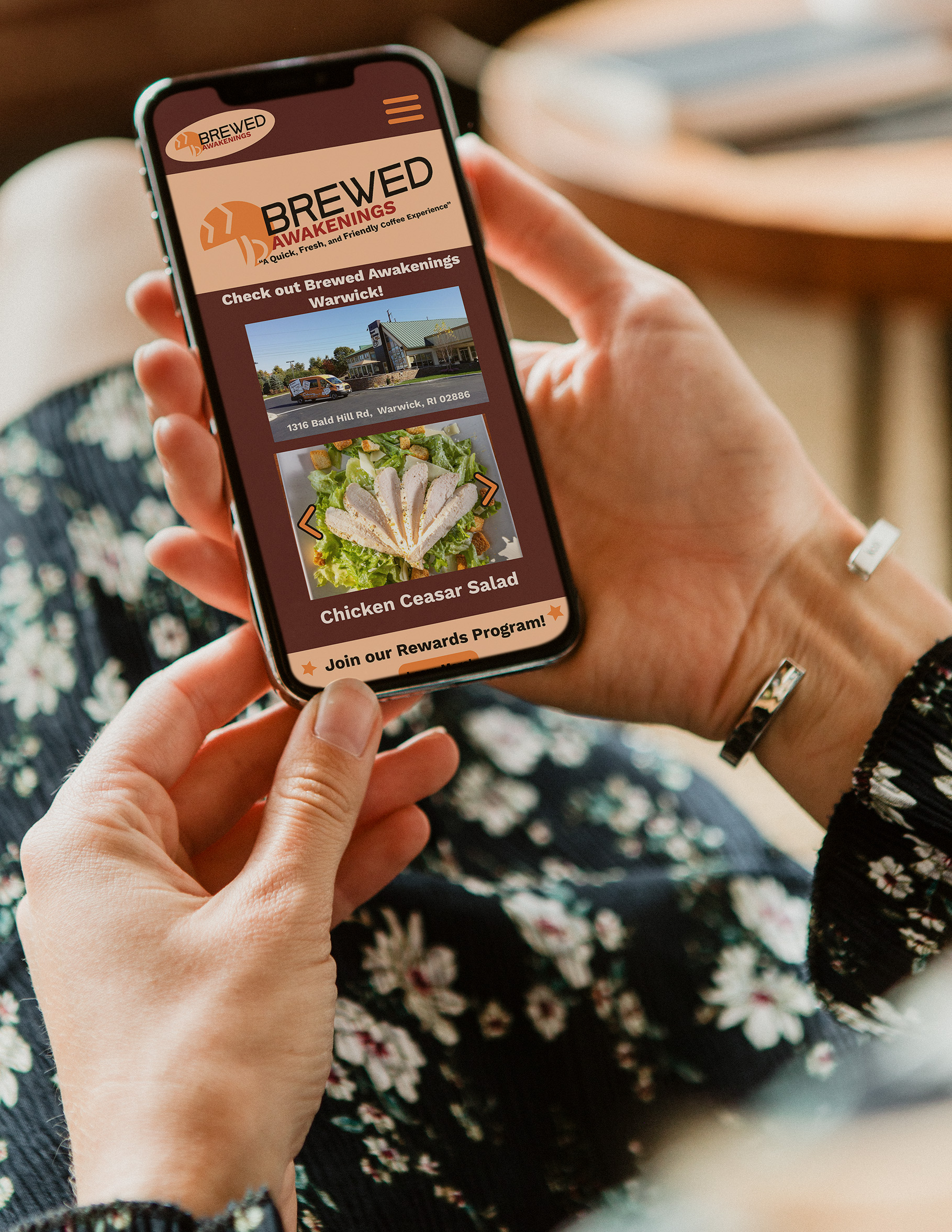 A mockup of a Brewed Awakenings cellphone app on a smartphone.
